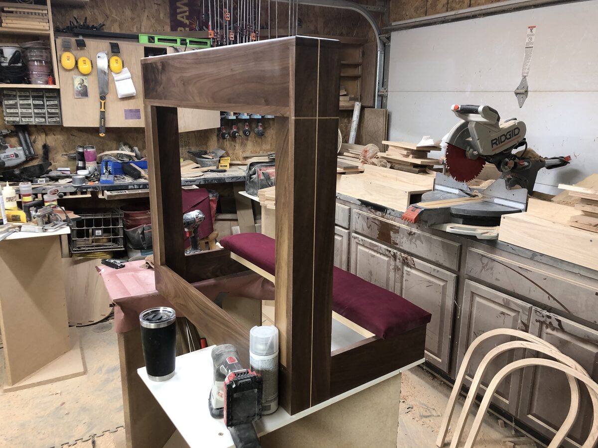 Walnut kneeler with burgundy upholstered cushion being built in the workshop