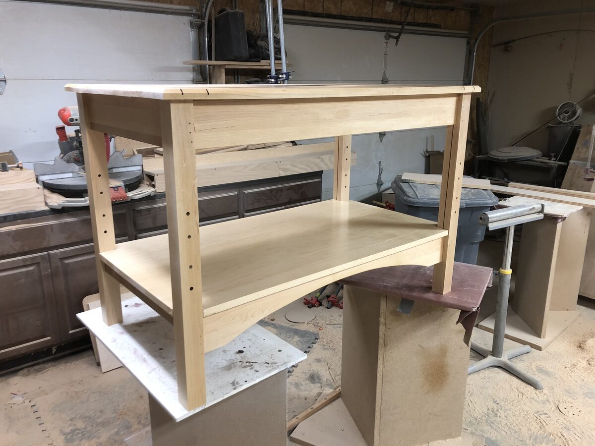 Custom bathroom vanity frame in maple with adjustable shelf being built in the workshop