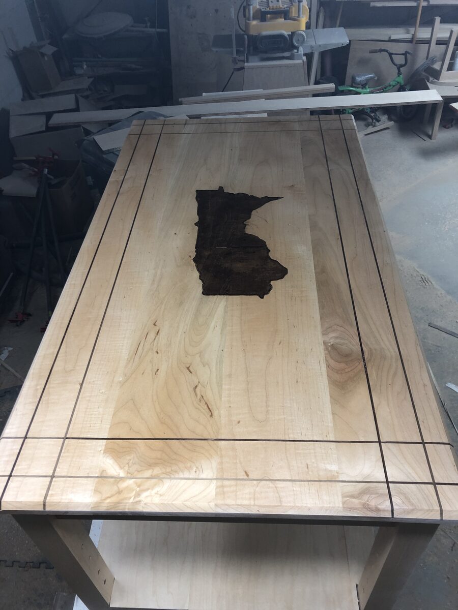 Custom maple countertop with inlaid Minnesota state shape in walnut