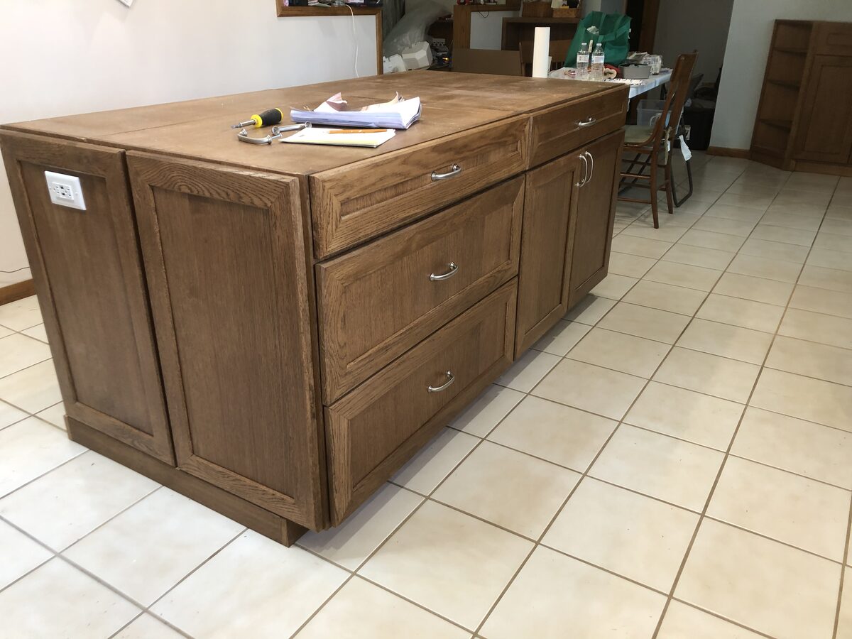 Custom oak kitchen island with raised panel doors and drawers