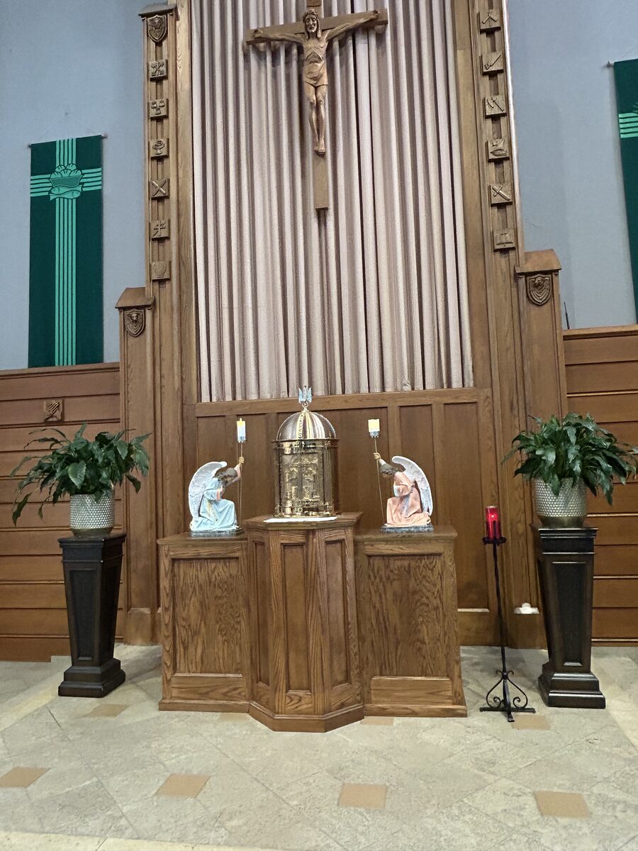 Church altar and tabernacle area with custom oak woodwork and carved crucifix